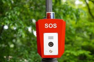 SOS, police, emergency button in the public park. photo