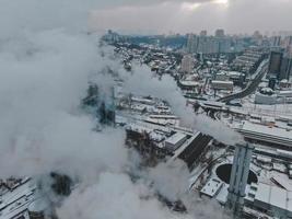 Large central boiler room with giant pipes of which there is dangerous smoke in winter during frost in a big city photo