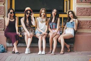 Five beautiful young girls relaxing photo