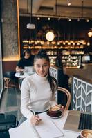 Young lady browsing the Internet at the cafe photo