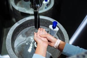 Man washing hands to protect against the coronavirus photo