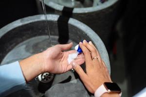 Man washing hands to protect against the coronavirus photo