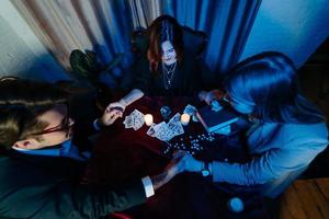 People hold hands of night at table with candles photo