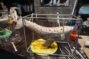 Clay whale on a stand in a pottery workshop photo