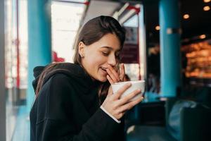 Close up portrait of pretty female drinking coffee. photo