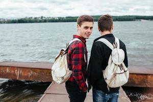 two young guys stand on the pier photo