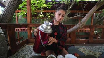 Process brewing tea. Woman steeping herbal tea photo