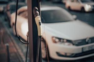 Electric car charging station, power supply plugged. photo