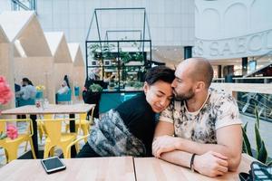 A man and a woman are sitting in a cafe photo