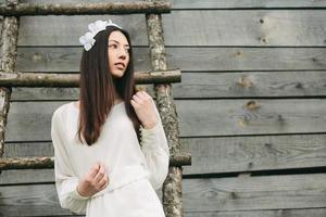 Lovely girl near a wooden house photo