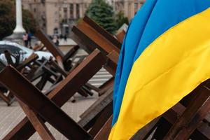 The Ukrainian flag hangs on barricades in the city photo