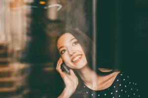 Beautiful girl talking on the phone and smiling photo