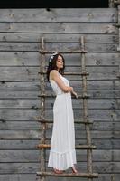 Lovely girl near a wooden house photo