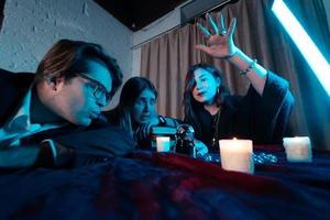 Group of people and woman fortune teller with crystal ball photo