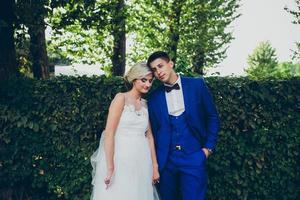 Beautiful wedding couple posing in the park photo