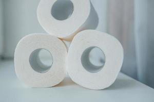 Toilet paper shortage concept with stacked rolls. photo