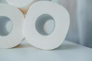 Toilet paper shortage concept with stacked rolls. photo