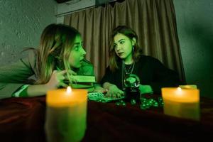 Fortune teller forecasting the future to woman with cards photo