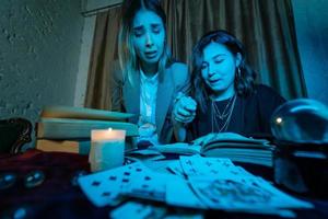 Two women are reading a mysterious book photo