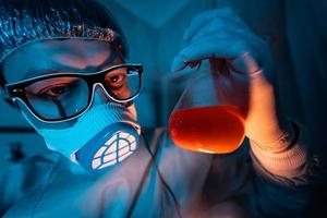 Young male researcher carrying out scientific experiment. photo