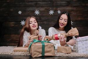 Two beautiful girls lie on the floor photo