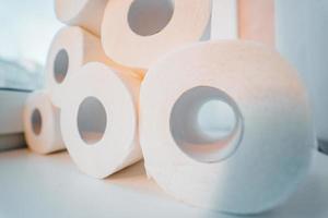 Toilet paper shortage concept with stacked rolls. photo