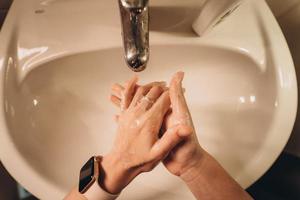 Man washing hands to protect against the coronavirus photo