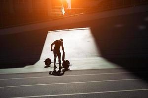 Handsome bodybuilder guy prepare to do exercises with barbell photo