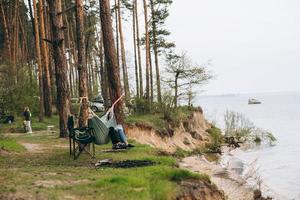 Couple Relaxing in a Hammock Overlooking the Water photo