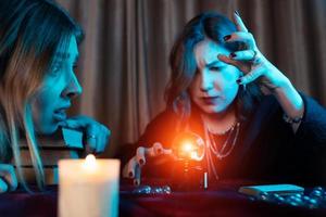 Woman and woman fortune teller with crystal ball photo