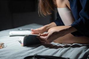 Side view woman working in dark bedroom. photo