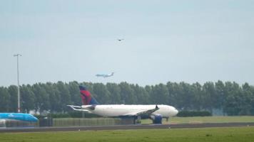 AMSTERDAM, THE NETHERLANDS JULY 25, 2017 - KLM Boeing 737 and Delta Airlines Airbus A330 taxis before departure at runway 36L Polderbaan. Shiphol Airport, Amsterdam, Holland video