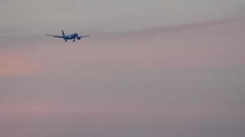 Widebody airplane approaching over ocean before landing in International Phuket Airport, beautiful sunset video