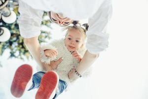 Mother and little daughter playing in a park photo