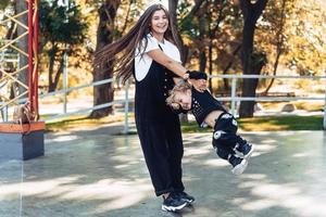 Mom and little boy cheerfully spinning around together. photo