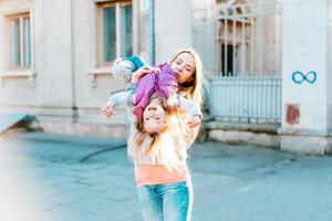 Mom and girl playing, having fun photo