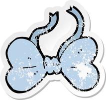 retro distressed sticker of a cartoon bow tie vector