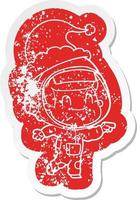 happy cartoon distressed sticker of a astronaut man wearing santa hat vector