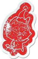 cartoon distressed sticker of a cat wearing santa hat vector