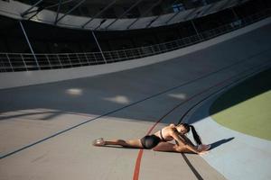 Young attractive female fitness woman performing a twine photo