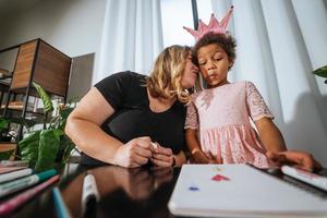 Mother and child daughter draws creatively at the table photo