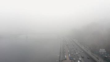 A city covered in fog. City traffic, aerial view photo