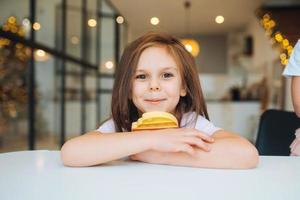 Adorable little girl looking at the camera close-up photo