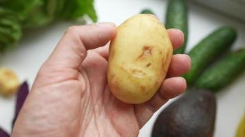 A man's hand holds potatoes, The concept of proper nutrition. photo