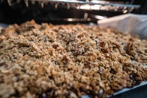 granola to cook in an electric oven. concept of simple ingredients for healthy breakfast photo