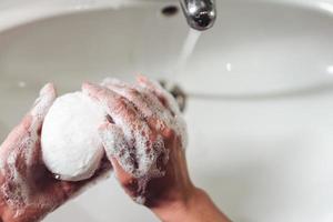 Man washing hands to protect against the coronavirus photo