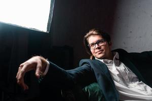 close-up portrait of an attractive young man relaxing on the couch photo