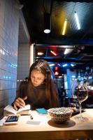 Woman works at a cafe in the evening photo