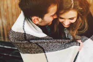 Young couple wrapped in plaid photo