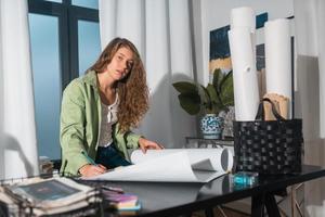 Portrait of young woman at her workplace in the home photo